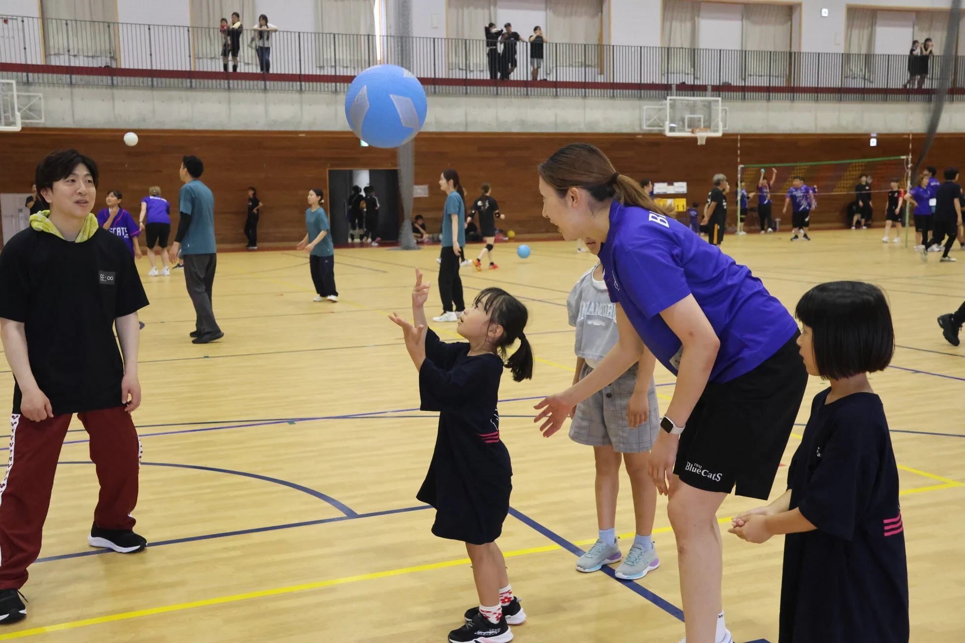 大人と子供が一緒にバレーボールを楽しむ様子